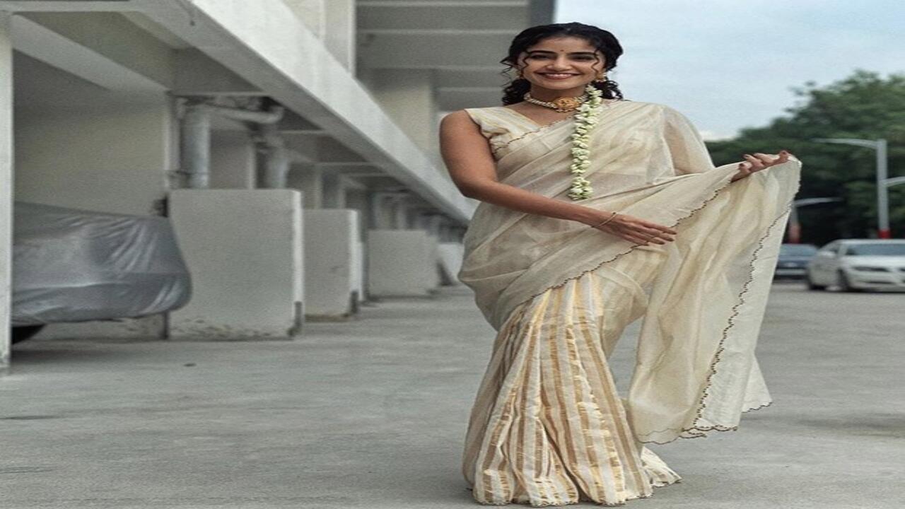 Anupama Parameswaran sends her best wishes for Onam dressed in a white and gold saree
