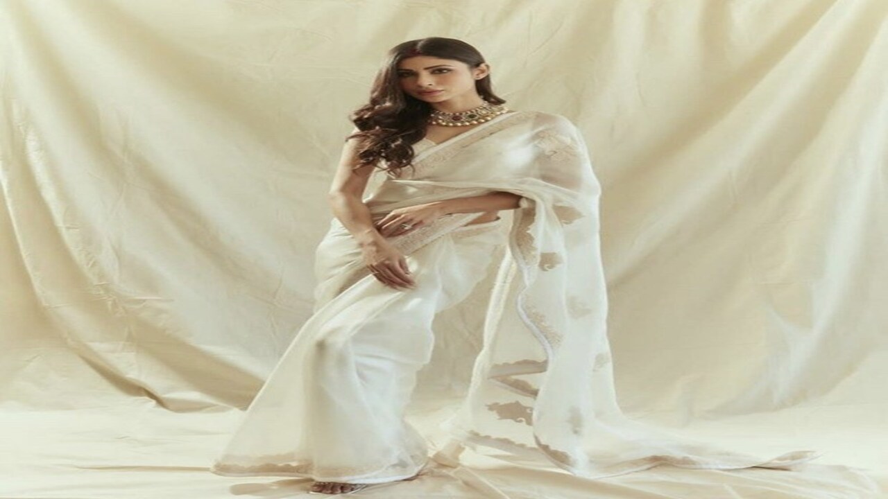 Mouni Roy dazzles in a white saree and a blouse with matching embellishments.